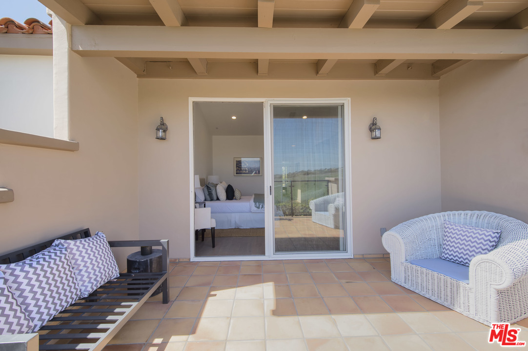 6450 Lunita Road, Unit 122 Malibu, CA 90265 - Photo 14 of 32 a bedroom with a bed and glass door