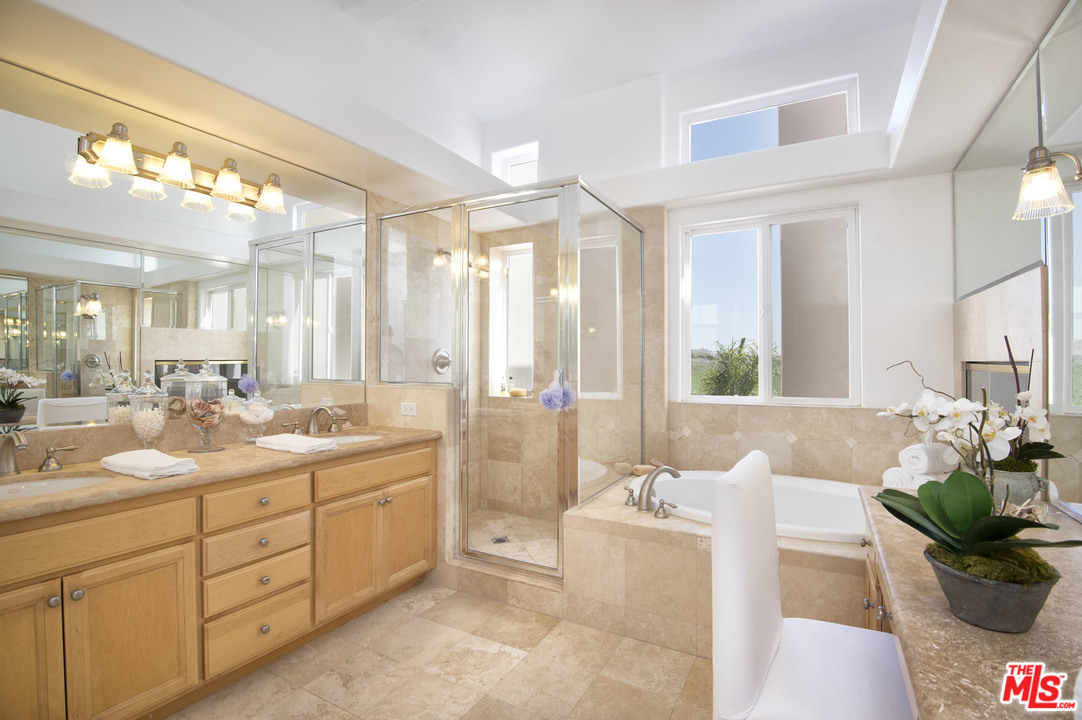 6450 Lunita Road, Unit 122 Malibu, CA 90265 - Photo 15 of 32 a spacious bathroom with a double vanity sink a mirror a bathtub and next to a window