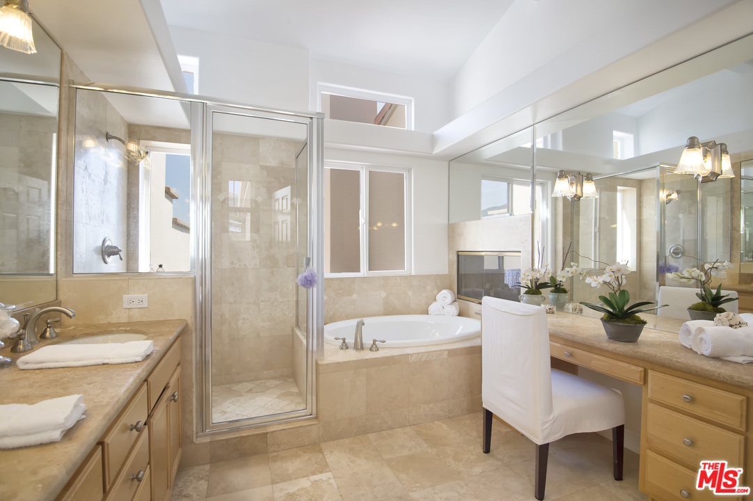 6450 Lunita Road, Unit 122 Malibu, CA 90265 - Photo 16 of 32 a spacious bathroom with a granite countertop tub sink and mirror