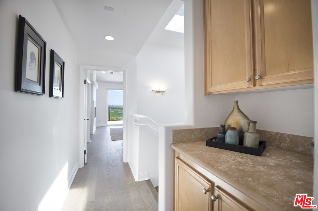 6450 Lunita Road, Unit 122 Malibu, CA 90265 - Photo 18 of 32 a kitchen with a refrigerator and cabinets