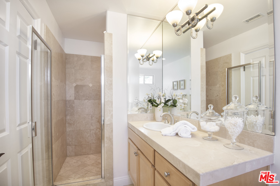 6450 Lunita Road, Unit 122 Malibu, CA 90265 - Photo 22 of 32 a bathroom with a sink vanity granite and a mirror