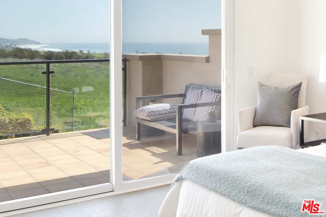 6450 Lunita Road, Unit 122 Malibu, CA 90265 - Photo 29 of 32 a bedroom with a bed and a view of balcony