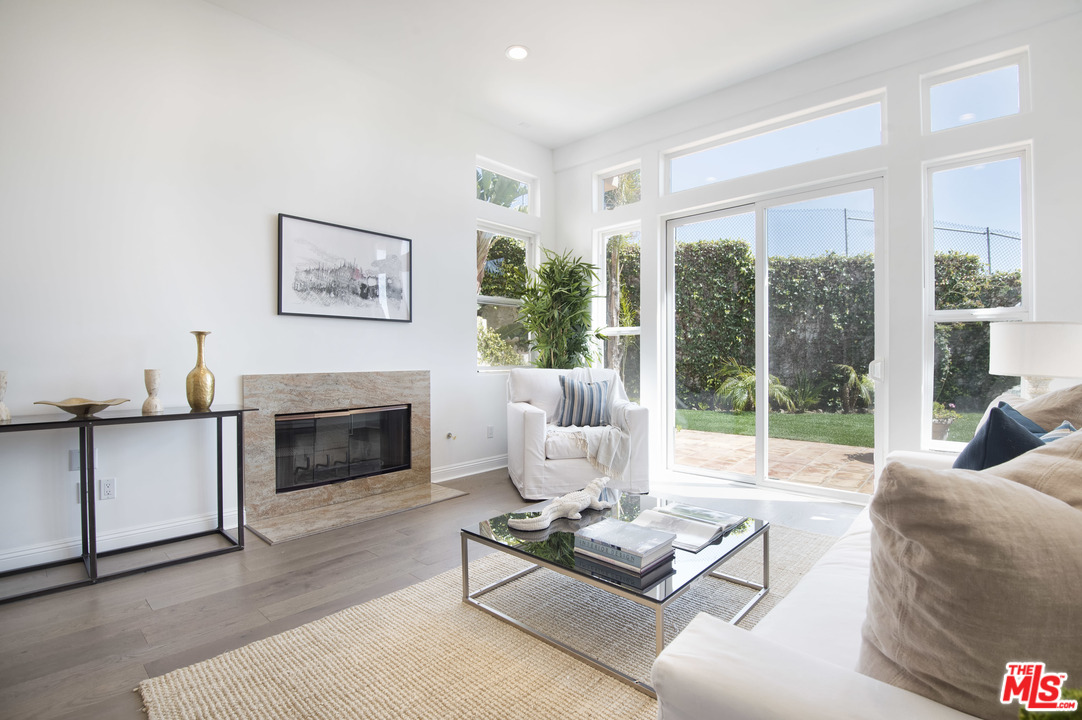 6450 Lunita Road, Unit 122 Malibu, CA 90265 - Photo 5 of 32 a living room with furniture large window and a fireplace