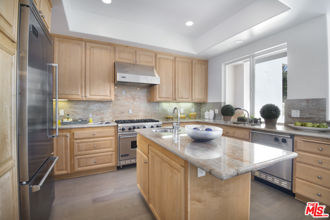 6450 Lunita Road, Unit 122 Malibu, CA 90265 - Photo 7 of 32 a kitchen with stainless steel appliances white cabinets and a stove top oven