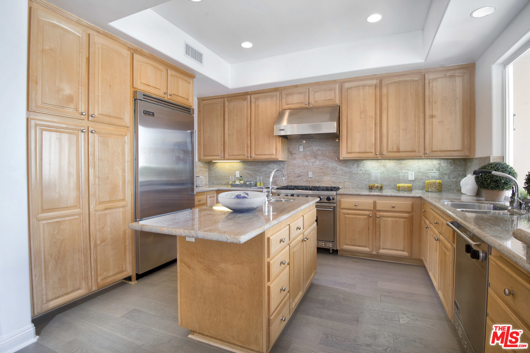 6450 Lunita Road, Unit 122 Malibu, CA 90265 - Photo 9 of 32 a kitchen with stainless steel appliances granite countertop a sink stove and refrigerator