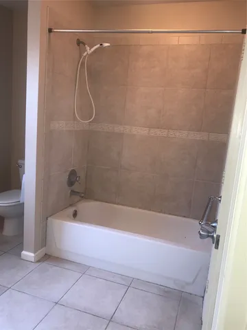 a bath tub sitting next to a white sink and a shower