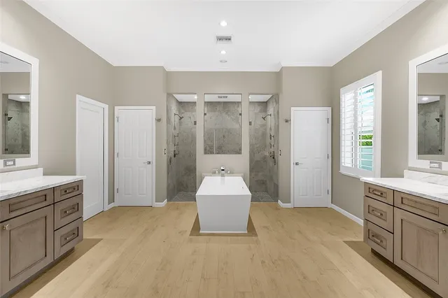 a spacious bathroom with a double vanity sink mirror and double