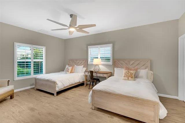 a bedroom with two beds and a window