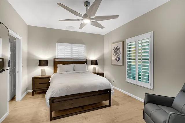 a bedroom with a bed a couch and a window