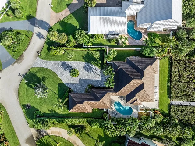 an aerial view of a house with a yard and outdoor seating