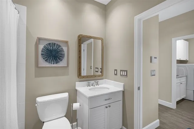 a bathroom with a toilet a sink and mirror