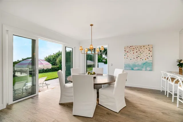 a dining room with furniture a garden view and a potted plants