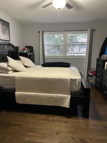 a bedroom with bed and window