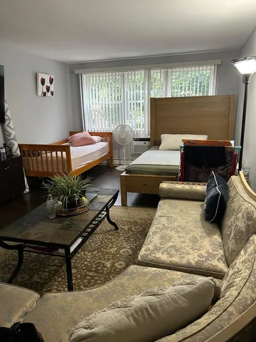 a living room with a table and chairs