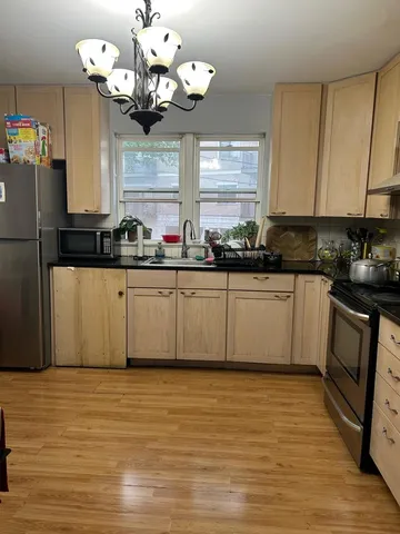 a room with a bed and a chandelier