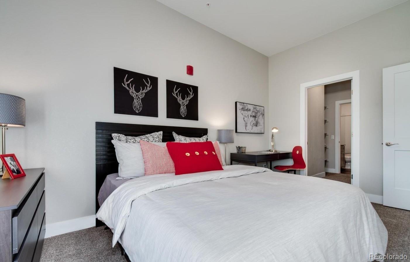 300 South Logan Street, Unit 211 Denver, CO 80209 - Photo 16 of 22 a bedroom with large bed and a bed