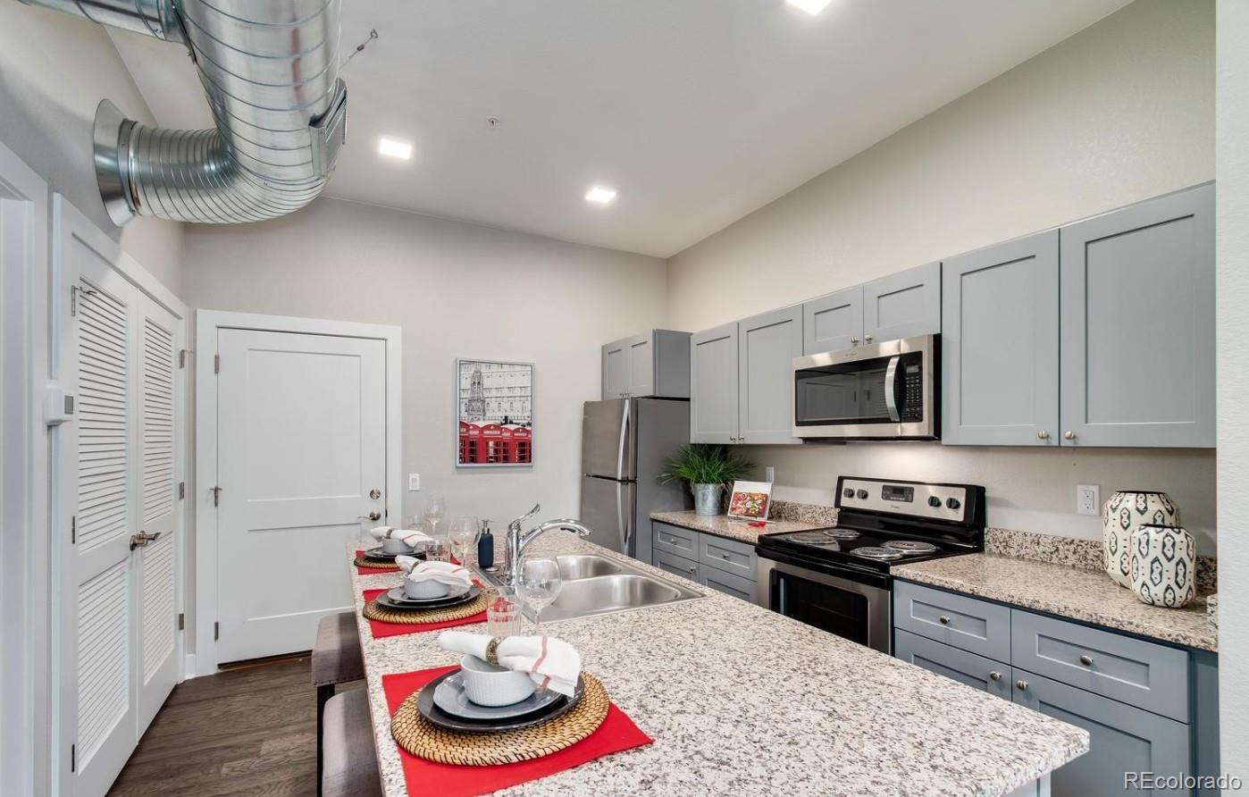 300 South Logan Street, Unit 211 Denver, CO 80209 - Photo 7 of 22 a kitchen with stainless steel appliances granite countertop a sink stove and cabinets