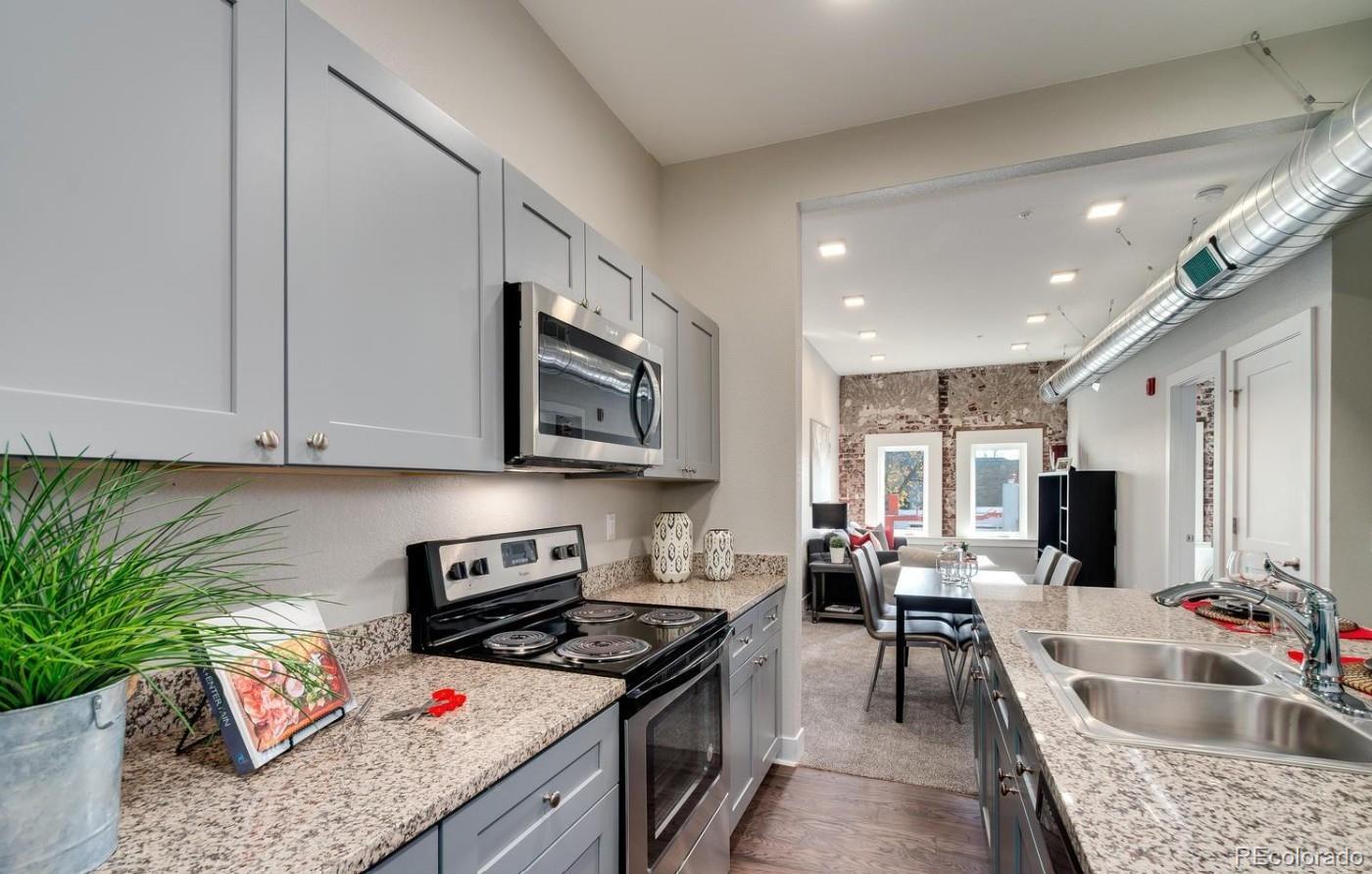 300 South Logan Street, Unit 211 Denver, CO 80209 - Photo 8 of 22 a kitchen with stainless steel appliances granite countertop a sink stove and cabinets