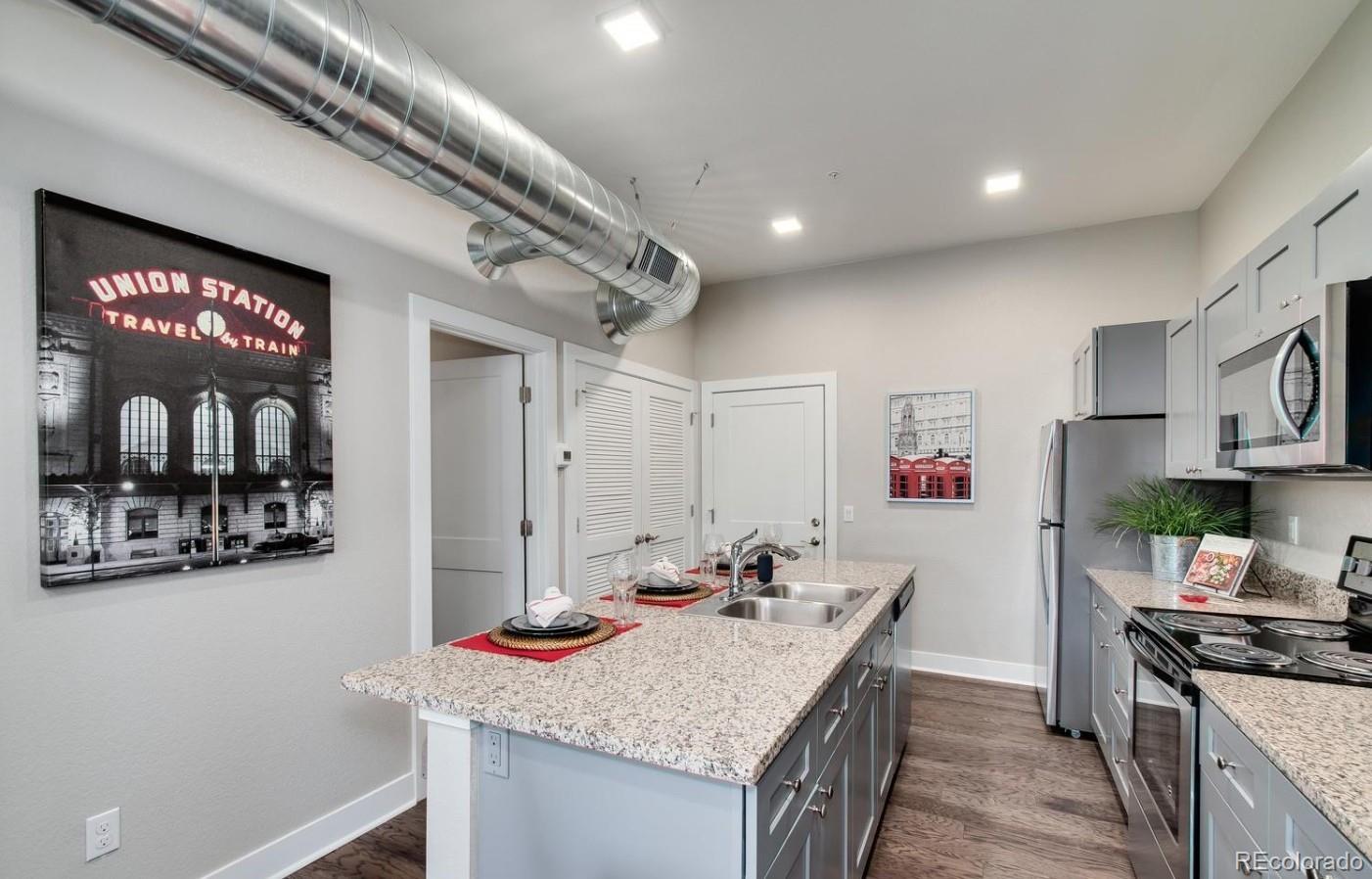 300 South Logan Street, Unit 211 Denver, CO 80209 - Photo 10 of 22 a kitchen with a sink stove and cabinets