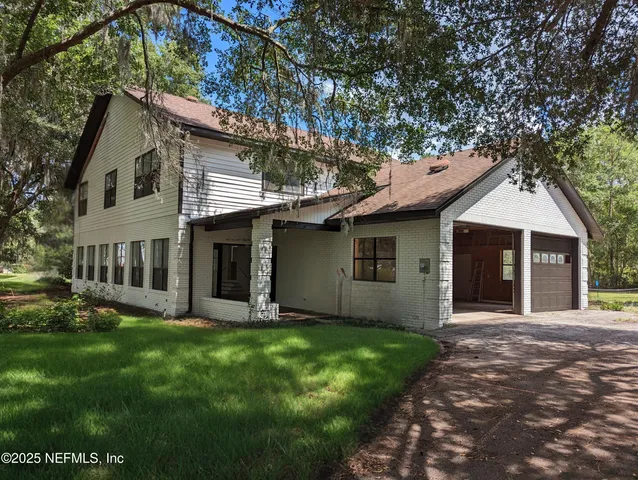 a front view of a house with a yard and porch