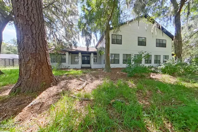 a front view of house with yard and green space