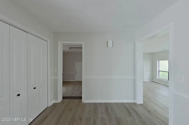 a view of a livingroom with wooden floor and white walls