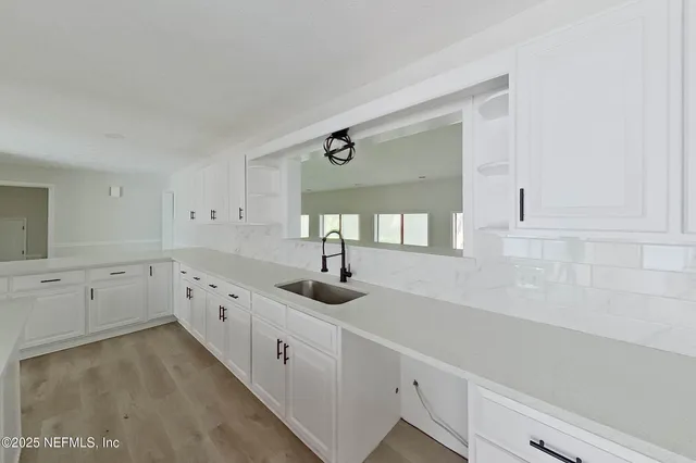 a kitchen with sink and cabinets
