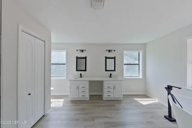 a view of kitchen with windows and cabinet