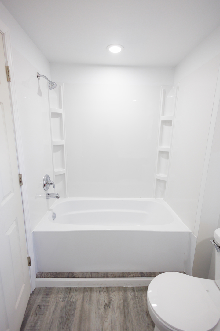 1581 South 16000E Road Pembroke Township, IL 60958 - Photo 16 of 24 a bathroom with a white toilet and a bathtub