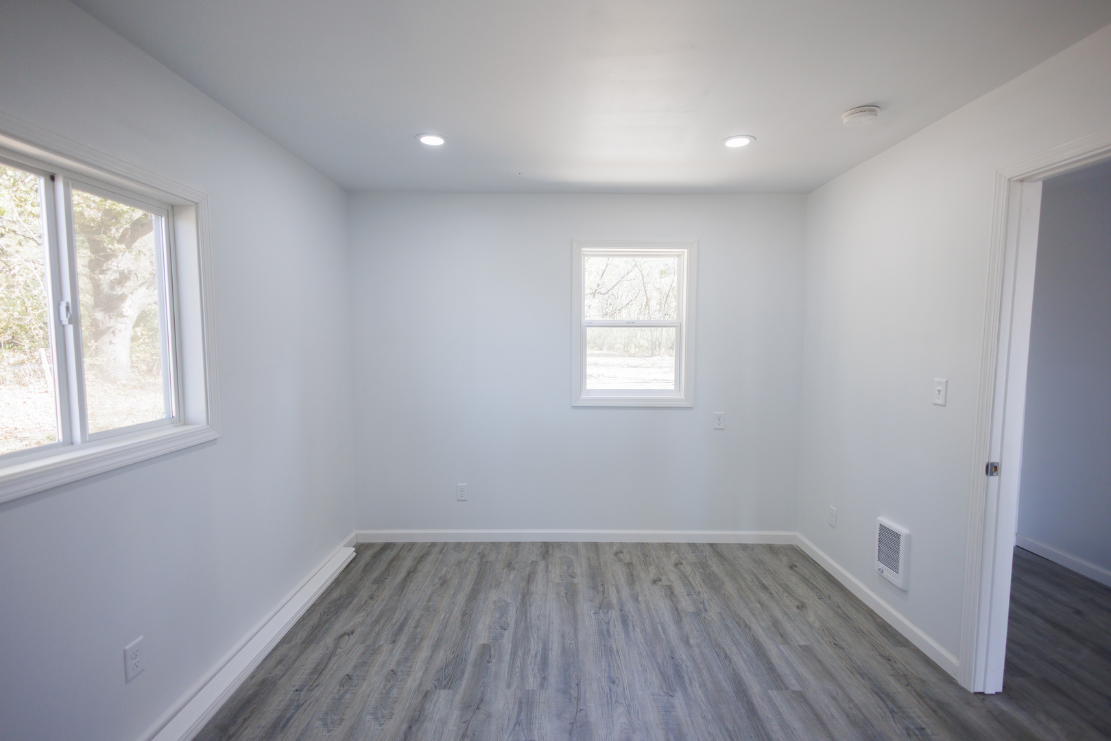 1581 South 16000E Road Pembroke Township, IL 60958 - Photo 18 of 24 an empty room with wooden floor and windows