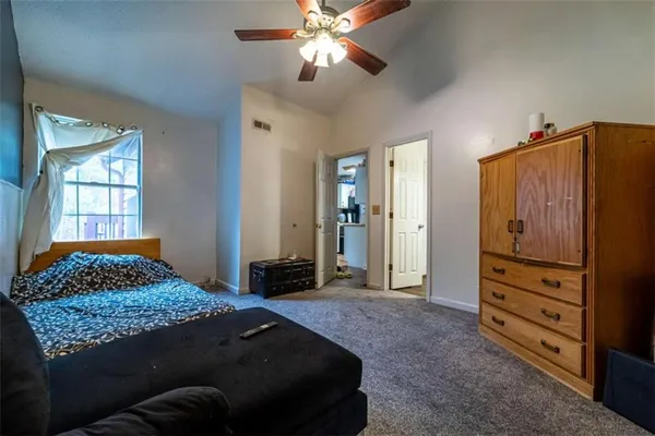 a bedroom with a bed and a dresser
