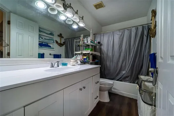 a bathroom with a sink a toilet and mirror