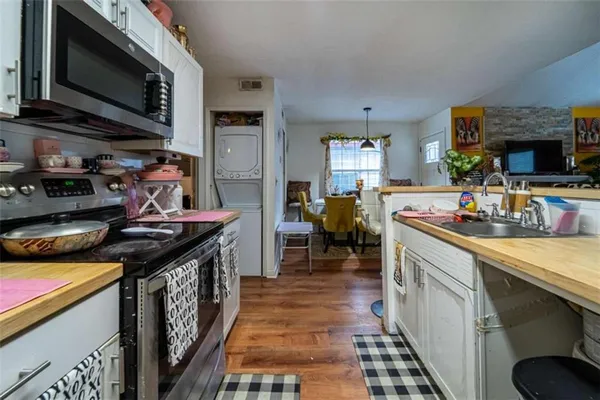 a kitchen with stainless steel appliances granite countertop a stove and a sink