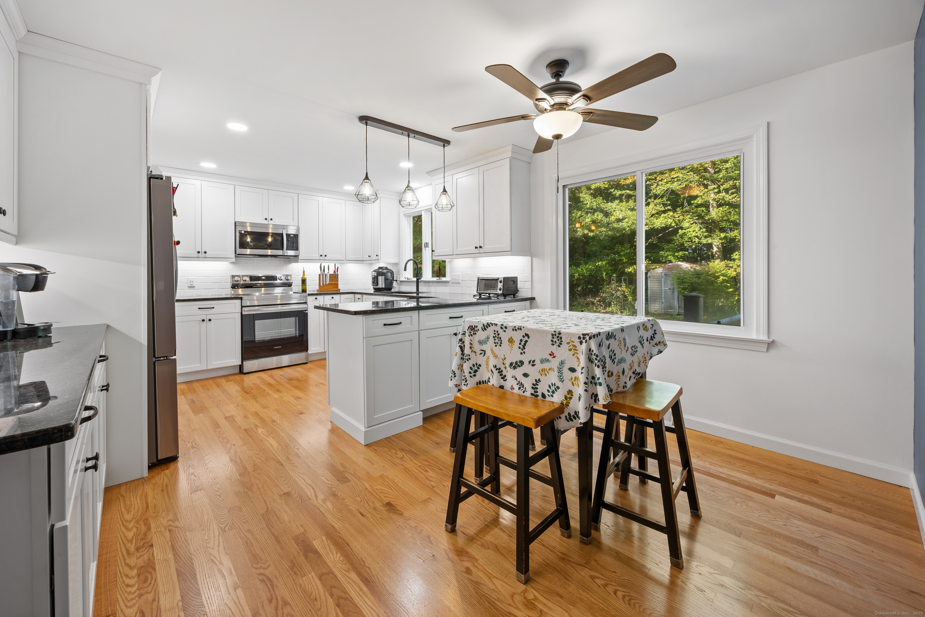 23 Hampden Road Somers, CT 06071 - Photo 2 of 37 a kitchen with stainless steel appliances a dining table chairs and wooden floor