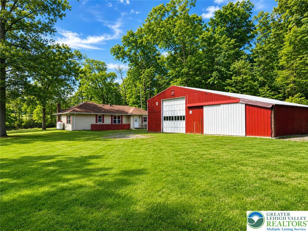4995 Mountain Road Slatington, PA 18080 - Photo 3 of 30 A spacious yard surrounds this charming home and a large, vibrant red outbuilding.