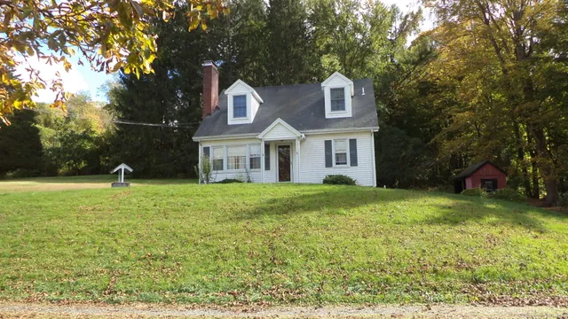 a front view of house with yard and trees