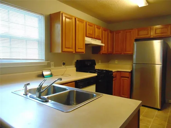 a kitchen with a refrigerator and a sink