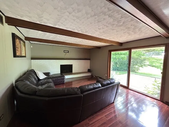 a living room with furniture and large windows