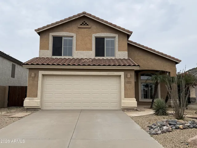 a front view of a house with garage