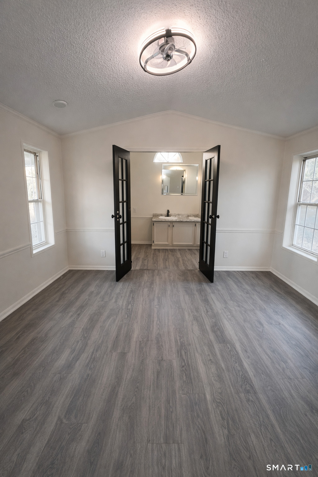 130 Williams Road Montville, CT 06370 - Photo 2 of 5 an empty room with wooden floor and windows