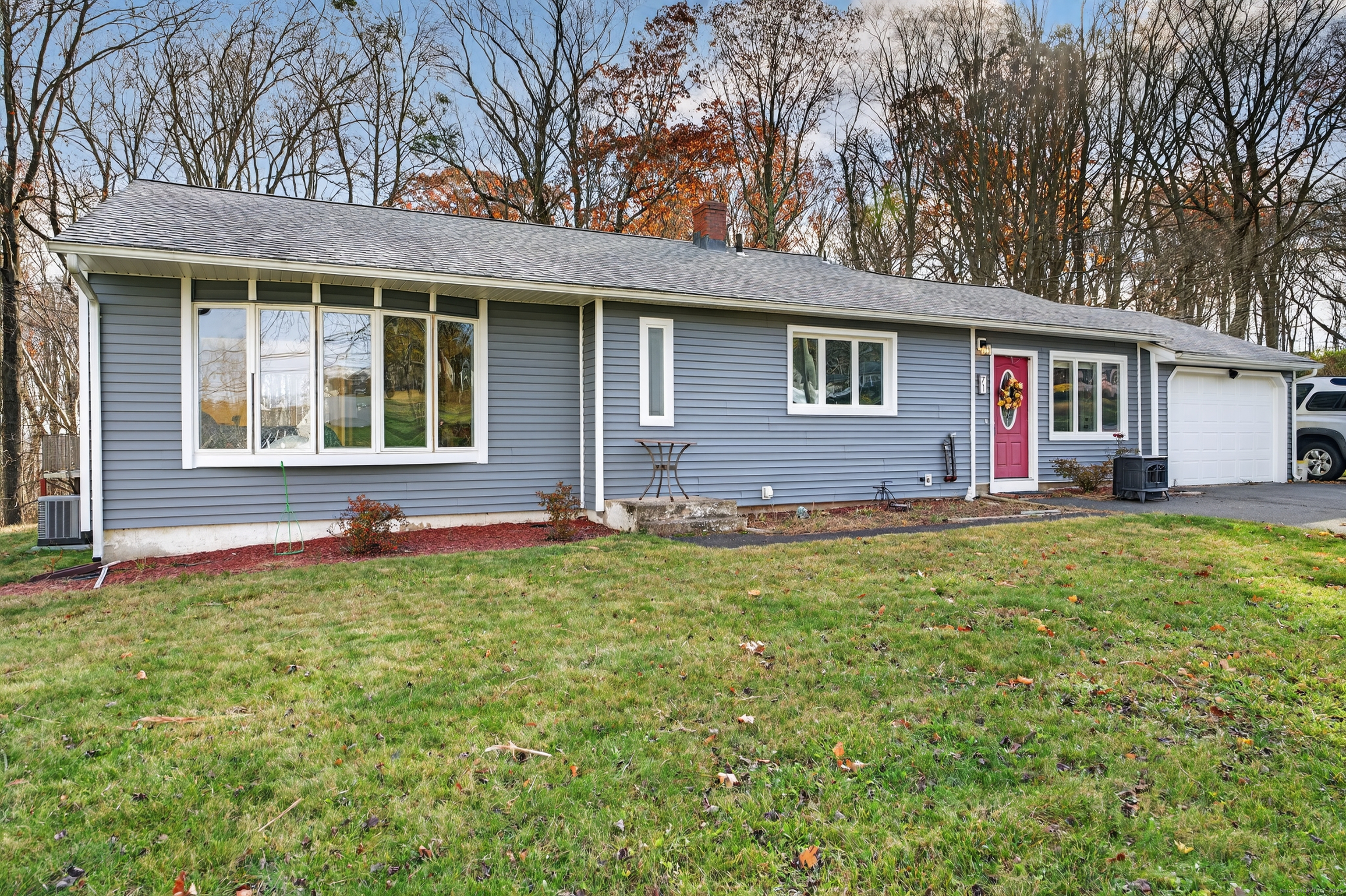 71 Mohawk Drive Wallingford, CT 06492 - Photo 1 of 1 a front view of house with yard and trees around