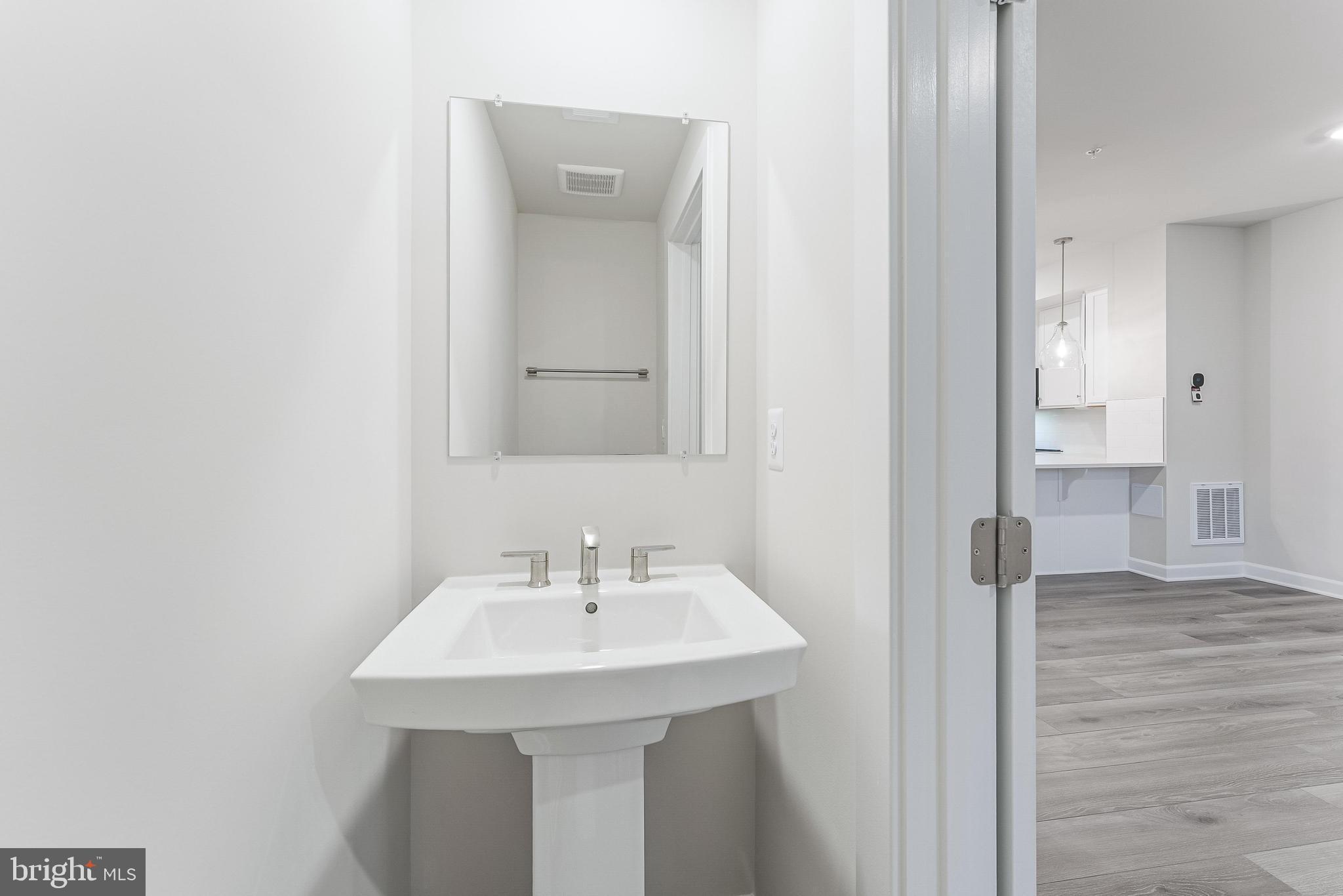 21815 Express Terrace Ashburn, VA 20147 - Photo 11 of 37 a bathroom with a sink a mirror and shower
