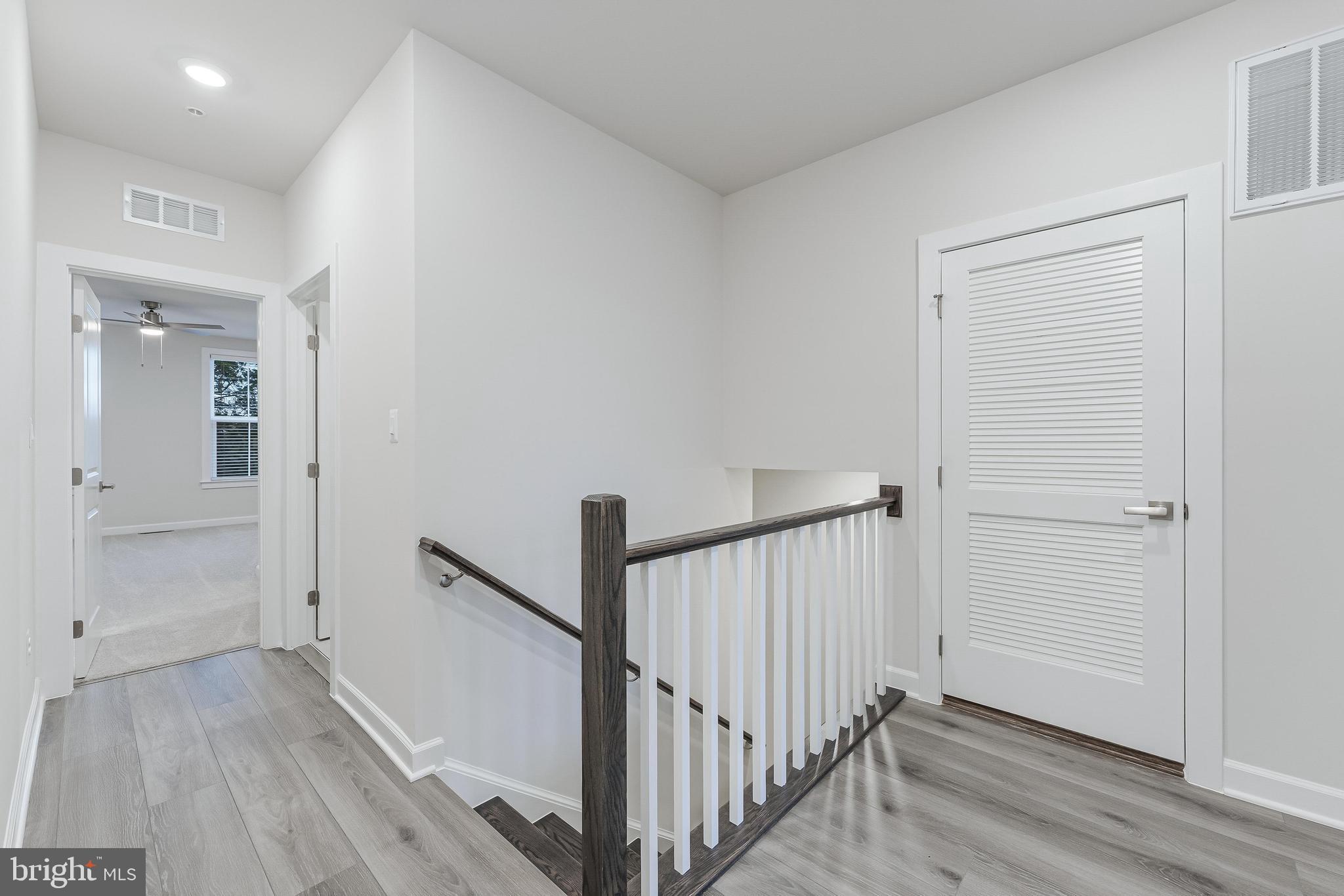 21815 Express Terrace Ashburn, VA 20147 - Photo 15 of 37 a view of a hallway with wooden floor and staircase