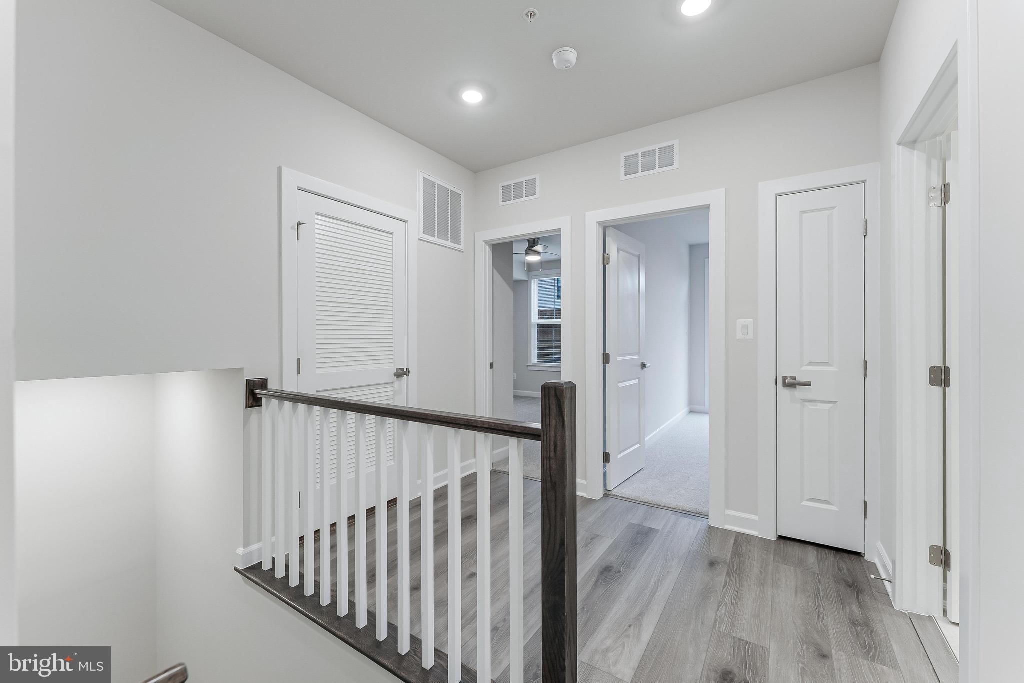 21815 Express Terrace Ashburn, VA 20147 - Photo 16 of 37 a view of a hallway with wooden floor
