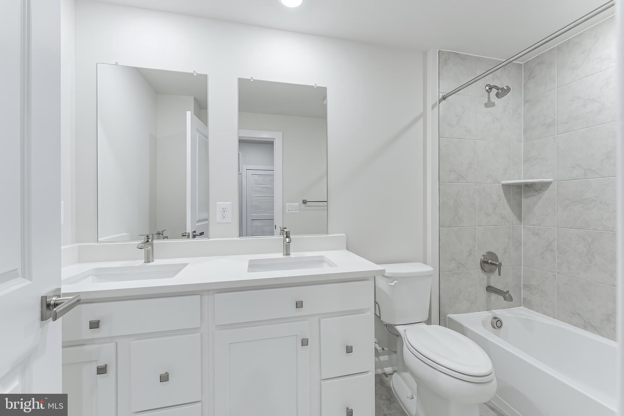 21815 Express Terrace Ashburn, VA 20147 - Photo 18 of 37 a bathroom with a sink a toilet and a large mirror