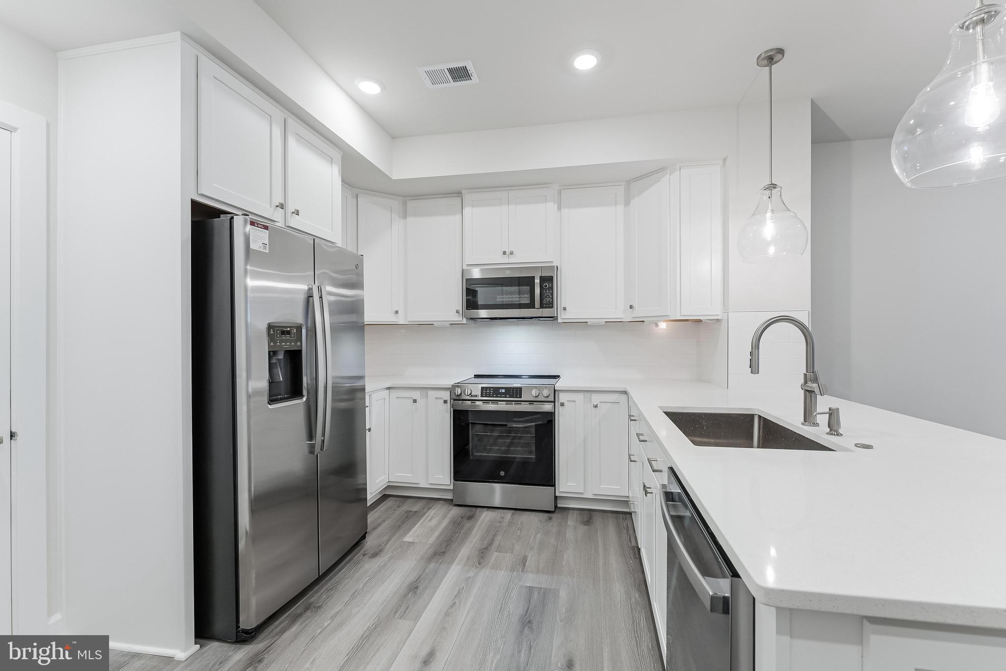 21815 Express Terrace Ashburn, VA 20147 - Photo 3 of 37 a kitchen with stainless steel appliances granite countertop a refrigerator and a stove top oven