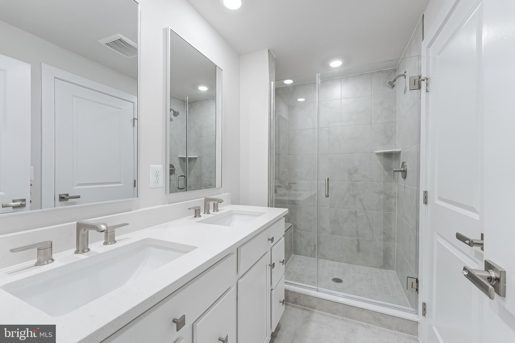 21815 Express Terrace Ashburn, VA 20147 - Photo 34 of 37 a bathroom with a shower tub double vanity sink and mirror