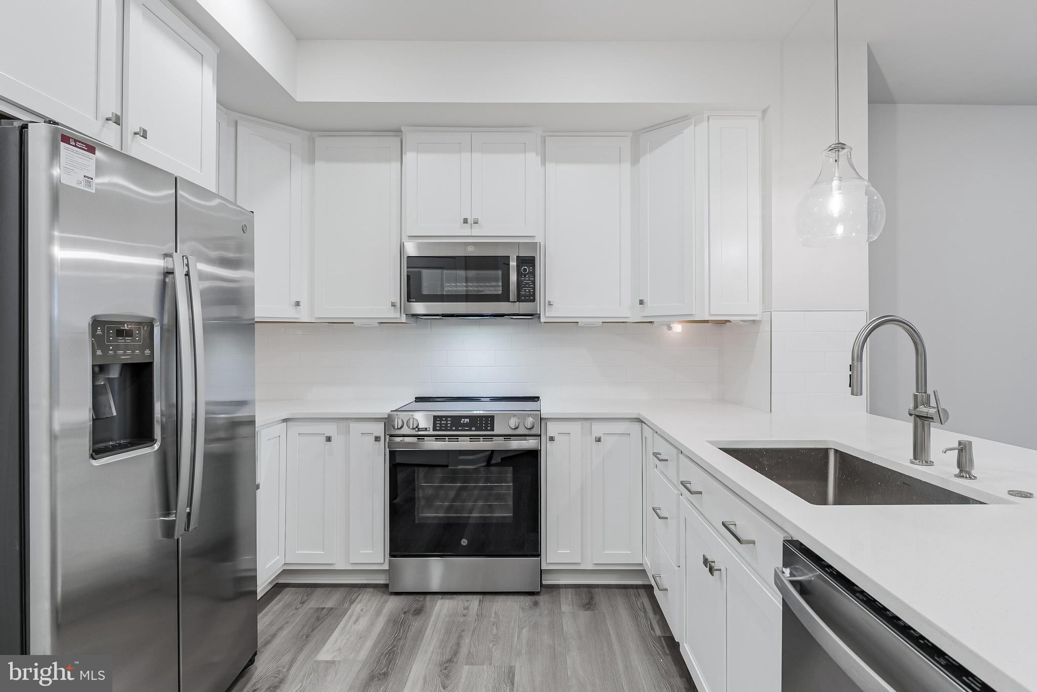 21815 Express Terrace Ashburn, VA 20147 - Photo 4 of 37 a kitchen with stainless steel appliances granite countertop a stove a sink and a refrigerator