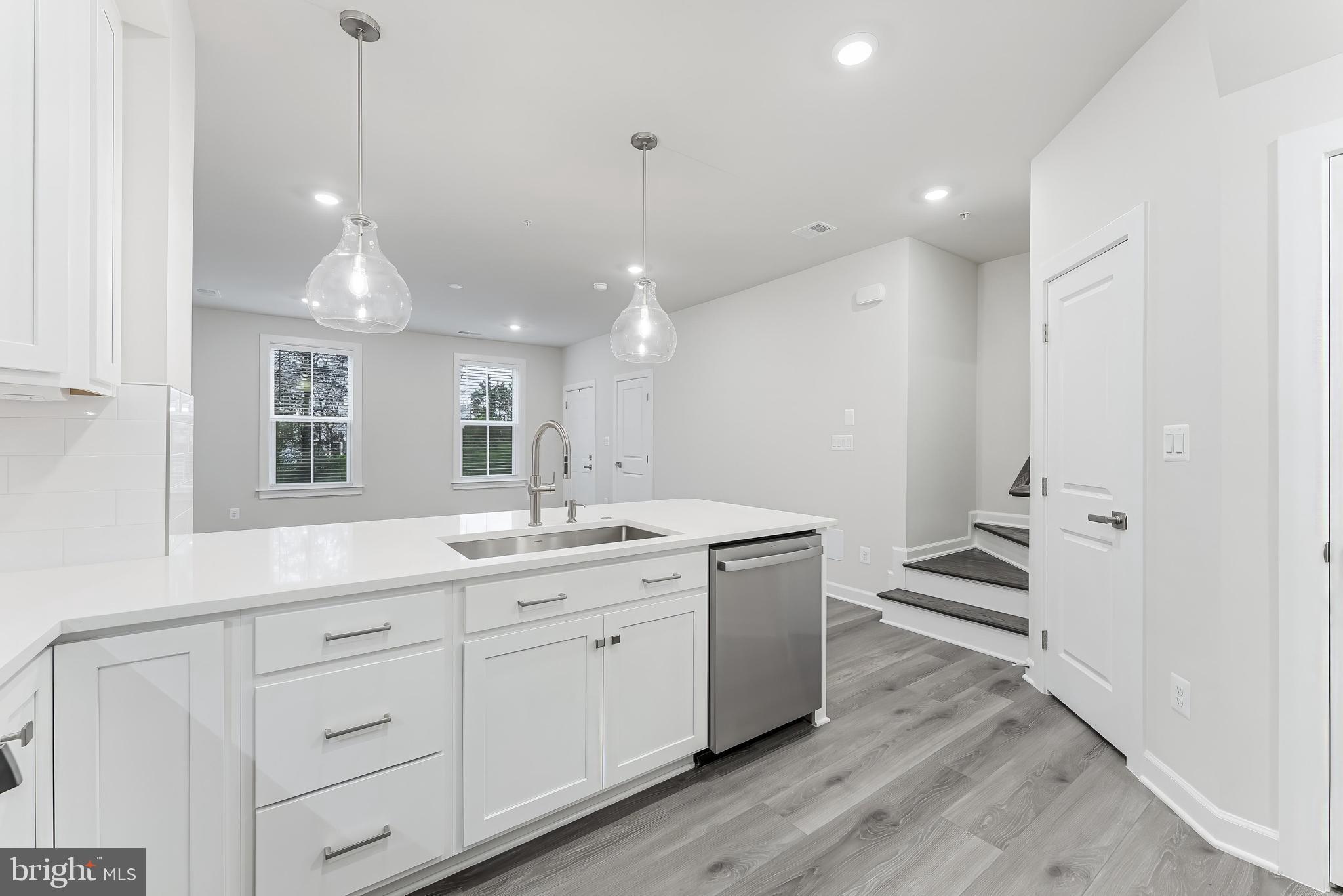 21815 Express Terrace Ashburn, VA 20147 - Photo 5 of 37 a kitchen with sink cabinets and wooden floor