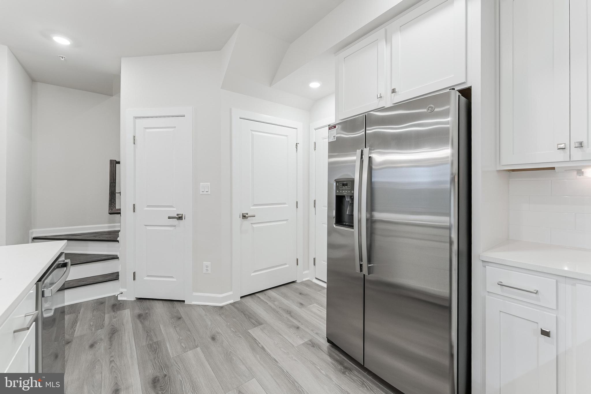 21815 Express Terrace Ashburn, VA 20147 - Photo 6 of 37 a kitchen with a refrigerator and wooden floor